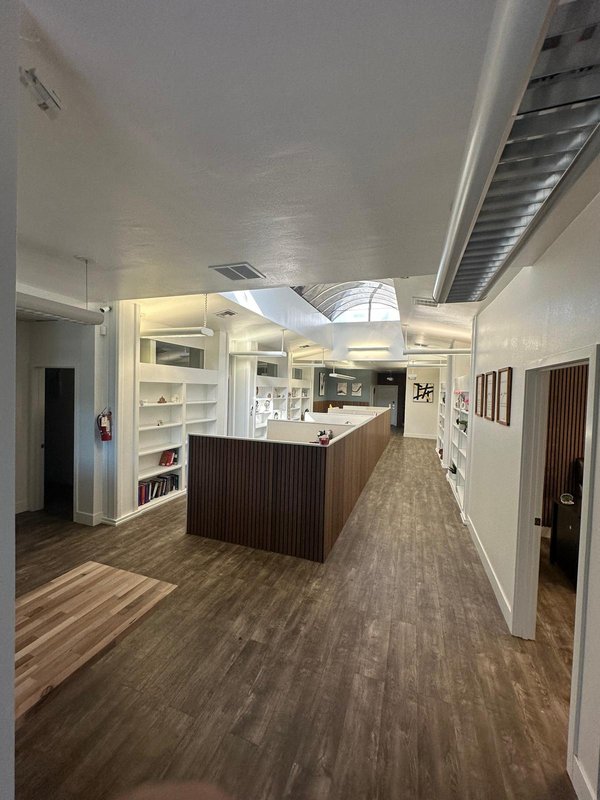 Open resident workspace with skylight and library shelving
